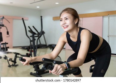 Woman Use Exercise Bike And Training