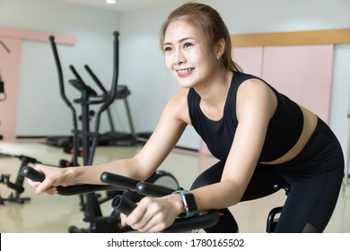 Woman Use Exercise Bike And Training