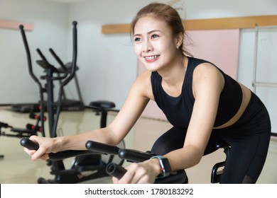 Woman Use Exercise Bike And Training