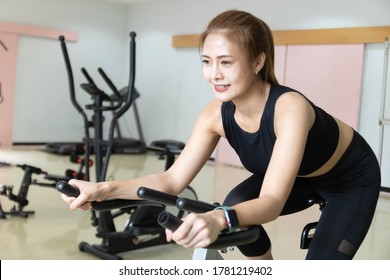 Woman Use Exercise Bike And Training