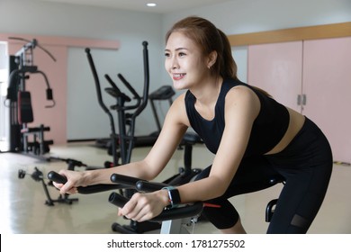 Woman Use Exercise Bike And Training