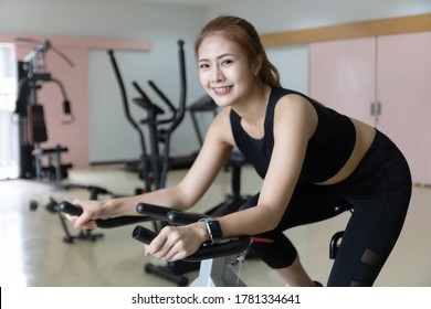 Woman Use Exercise Bike And Training