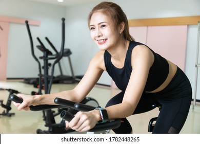 Woman Use Exercise Bike And Training