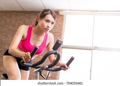 Woman Use Exercise Bike And Training Hard