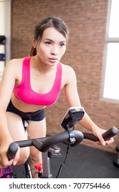 Woman Use Gym Flywheel And Training Hard