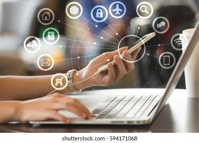 Woman use laptop and smartphone with IOT, internet of things conceptual sign, internet era, internet in every day lifes - Shutterstock ID 594171068