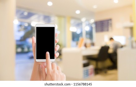 Woman Use Mobile Phone And Blurred Image Of Reception Area Of Dental Clinic