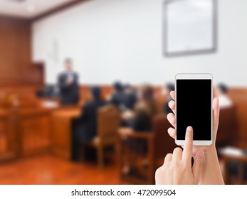 Woman Use Mobile Phone And Blurred Image Of People In Court Room