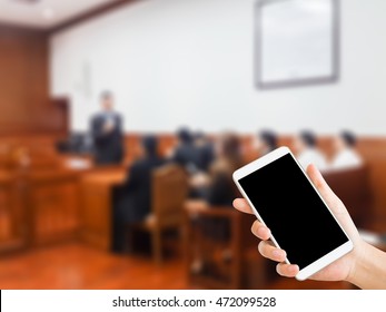 Woman Use Mobile Phone And Blurred Image Of People In Court Room