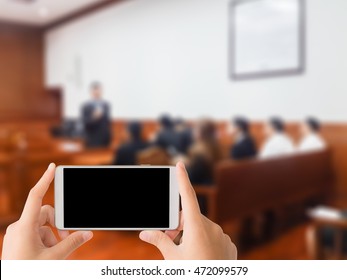 Woman Use Mobile Phone And Blurred Image Of People In Court Room