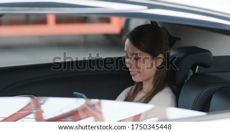 Woman use mobile phone in car