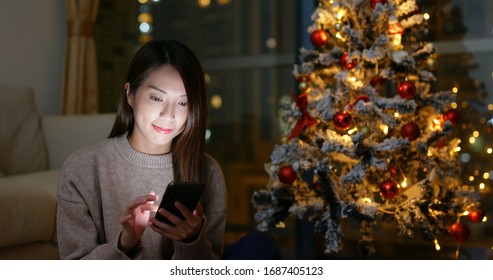 Woman Use Of Mobile Phone At Christmas Time