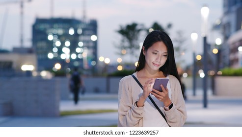 Woman Use Of Mobile Phone In City At Night