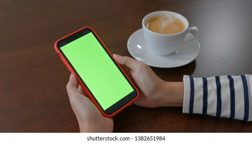 Woman use of mobile phone with green screen  - Powered by Shutterstock