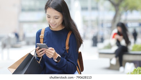 Woman Use Of Mobile Phone And Holding Shopping Bag 