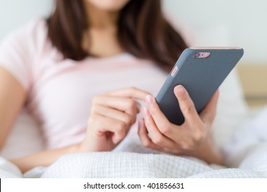 Woman Use Of Mobile Phone On Bed