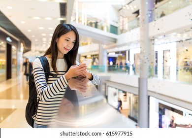 Woman Use Of Mobile Phone In Shopping Center