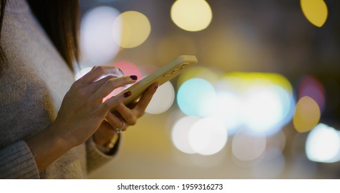 Woman Use Of Mobile Phone In Street At Night