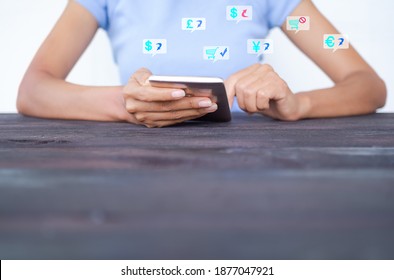 Woman use mobile or smarthpone with symbols money usd, euro, gbp, krw, cny  for working earn money and shopping online technology. Business and financial for money saving or investment concept.  - Shutterstock ID 1877047921