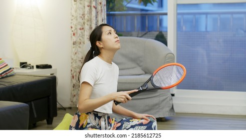 Woman Use Mosquito Swatter At Home