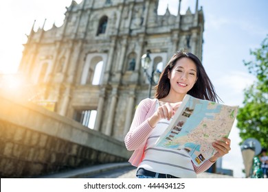 Woman use of paper map in macau city - Shutterstock ID 444434125