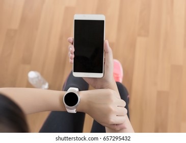 Woman Use Phone  Fitness Exercise In Gym Smart Gadgets And Sport Applications