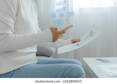 woman use phone scan barcode or QR codes to pay credit card bill after receiving document invoice. payment, receive, paying electricity, digital payments, technology, scanning, financial transactions