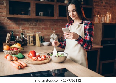 Woman Use Phone While Cooking Vegetable Salad