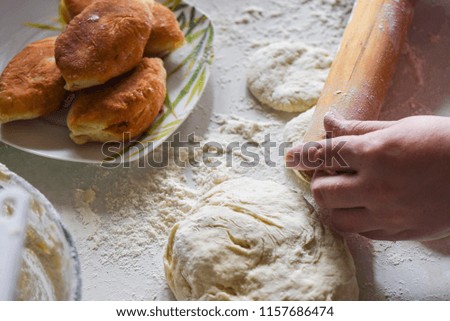 Woman use a rolling pin to press down on the pastry