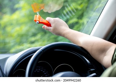 Woman Use Safety Hammer And Seatbelt Cutter In Cars, Break Glass When Emergency. In Case Of Emergency On Car Safety Red Hammers To Break The Grass Window.