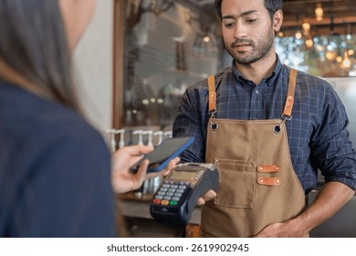 Woman use smartphone to scan QR code to pay in cafe restaurant with a digital payment without cash. Choose menu and order accumulate discount. E wallet, technology, pay online, credit card, bank app.