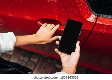 Woman Use Smartphone And Try To Open Car Door