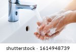 Woman use soap and washing hands under the water tap. Hygiene concept hand detail.