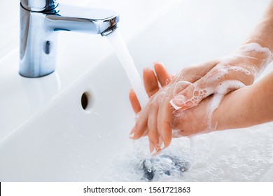 Woman Use Soap And Washing Hands Under The Water Tap. Hygiene Concept Hand Detail.