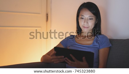 Woman use of tablet at night 