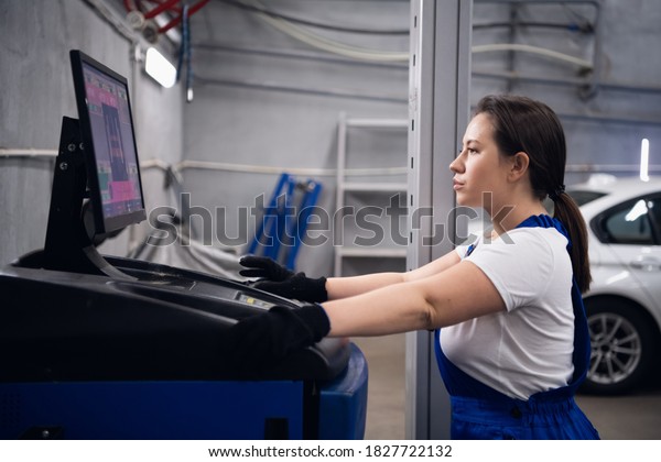 A woman uses\
a computer to work in a\
workshop