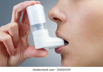 Woman Uses An Inhaler During An Asthma Attack, Close-up