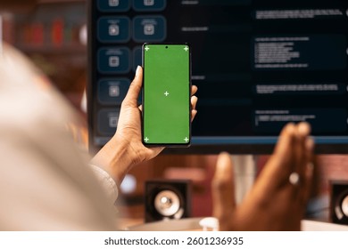 Woman uses isolated screen phone, doing online videocall in front of PC screen with AI LLM chatbot, close up. Person uses large language model program during teleconference on chroma key smartphone - Powered by Shutterstock - Get 15% off with code: PIKWIZARD15