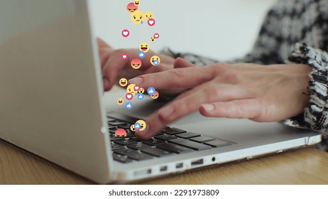 Woman uses laptop computer, types chat messages. 3D emoji, meme icons flying out of device. - Powered by Shutterstock