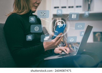 A woman uses a laptop and smartphone, showcasing AI-powered cloud computing. Integration of technology in modern life, accessibility and efficiency. AI, cloud computing, tech advancements concepts.