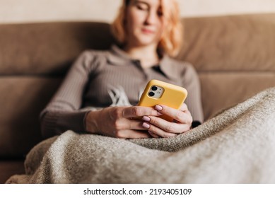 Woman Uses Smartphone. Female Hands Use Phone, Thumb Scrolls Up Screen. Close-up.