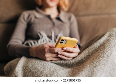 Woman Uses Smartphone. Female Hands Use Phone, Thumb Scrolls Up Screen. Close-up.