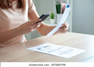 A Woman Uses A Smartphone To Scan The Barcode To Pay Monthly Phone Bills After Receiving An Invoice Sent To Home. Online Bill Payment Concept