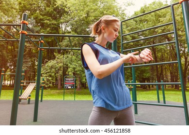 Woman Using Activity Tracker At Gym