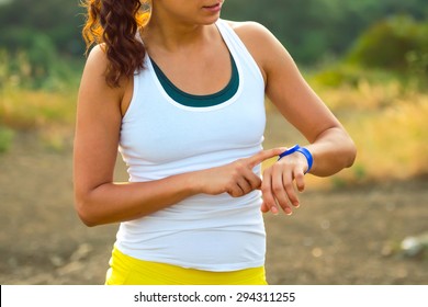 Woman Using Activity Tracker Or Heart Rate Monitor. Outdoor Fitness Concept