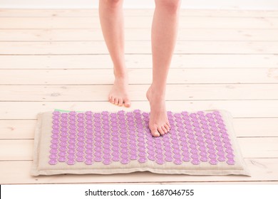 Woman Using Acupressure Mat. Home Self Massage, Acupuncture Concept.
