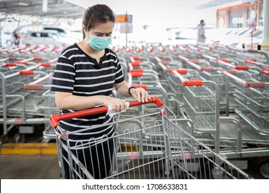 Woman Using Alcohol Wet Cloth,wipes The Trolley Handle With Disinfecting Cloth,cleaning The Surface With Disinfectant On Shopping Cart,hygienic,prevention,during The Coronavirus Pandemic Or Covid-19