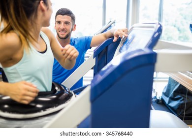 Woman Using An Anti Gravity Treadmill Beside Trainer At The Gym