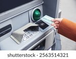 woman using a atm to pay the money.