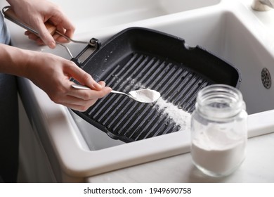 Woman using baking soda to grill pan indoors, closeup - Shutterstock ID 1949690758